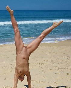 adorable young female nudists fully exposed on a nudist beach